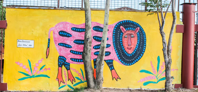 A exterior mural depicting an animal in expressive and bold colors.