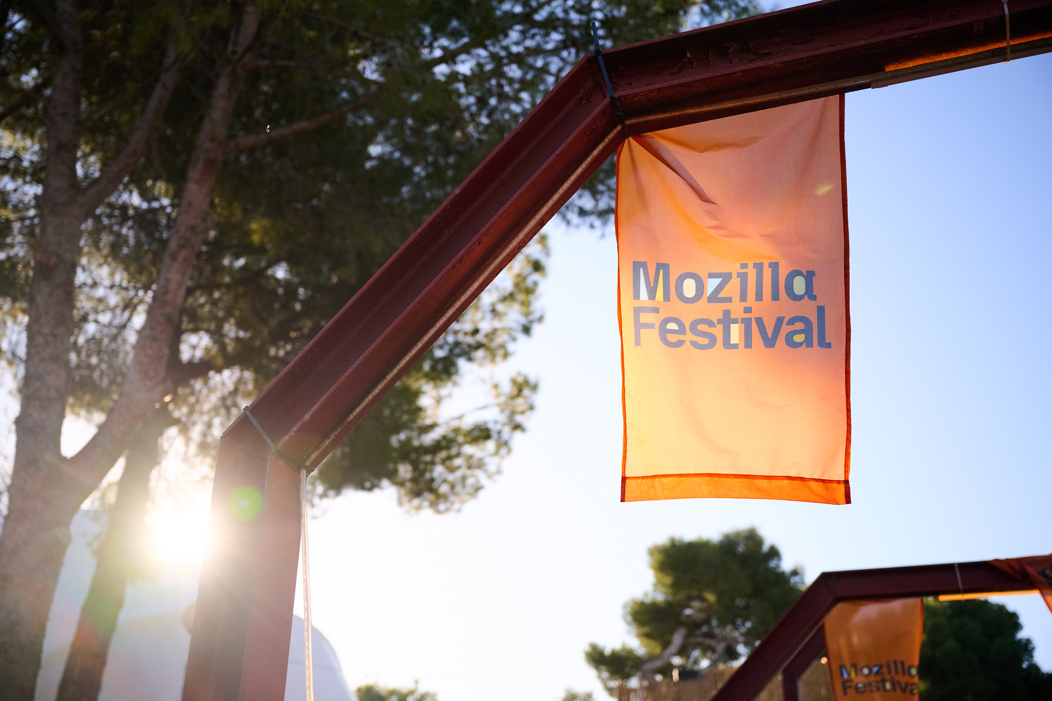 The flag of Mozfest against a blue sky.